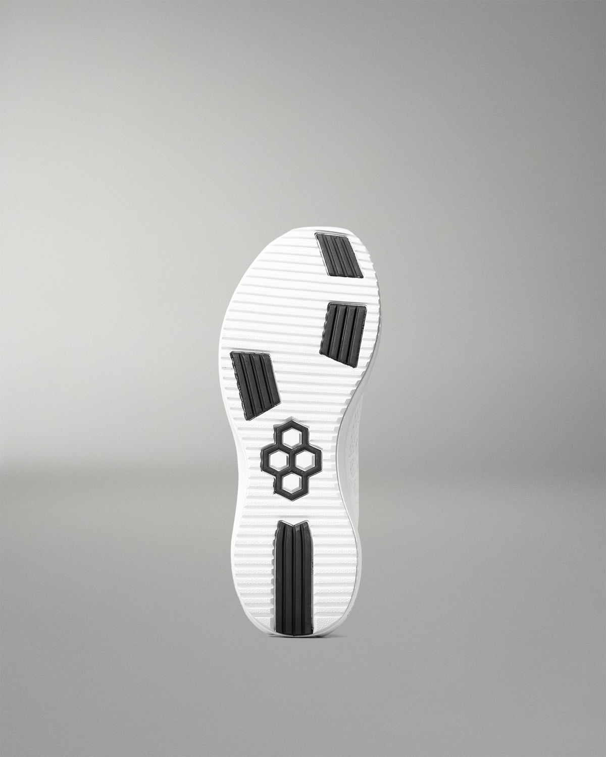 White shoe sole with black accents on a gray background