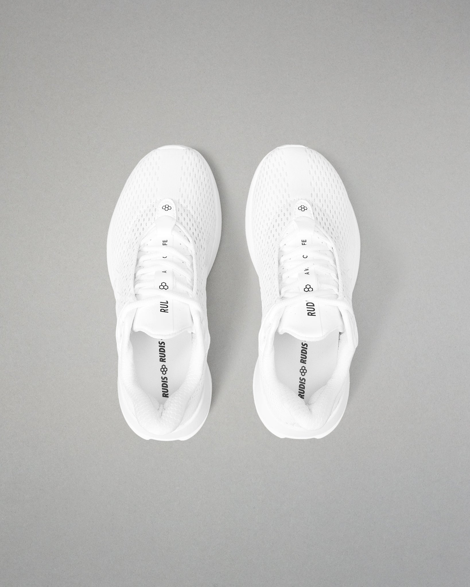 White sneakers with black text on a gray background