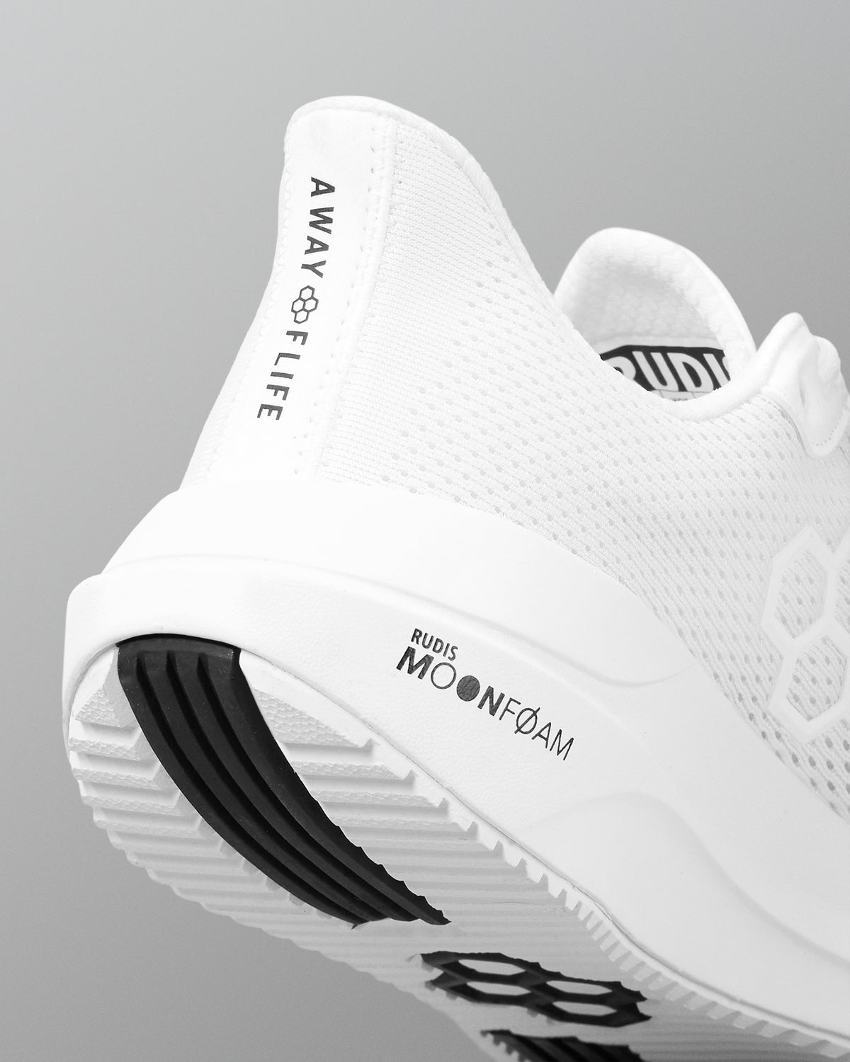 White athletic shoe with branding on a gray background