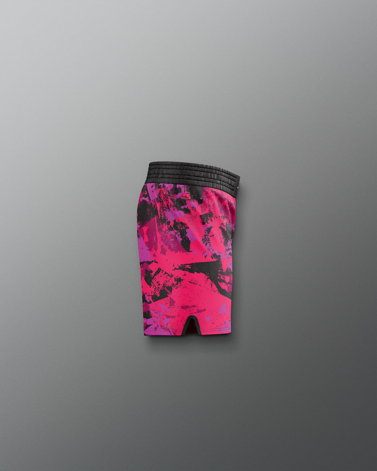 Pink and black patterned shorts on a gray background