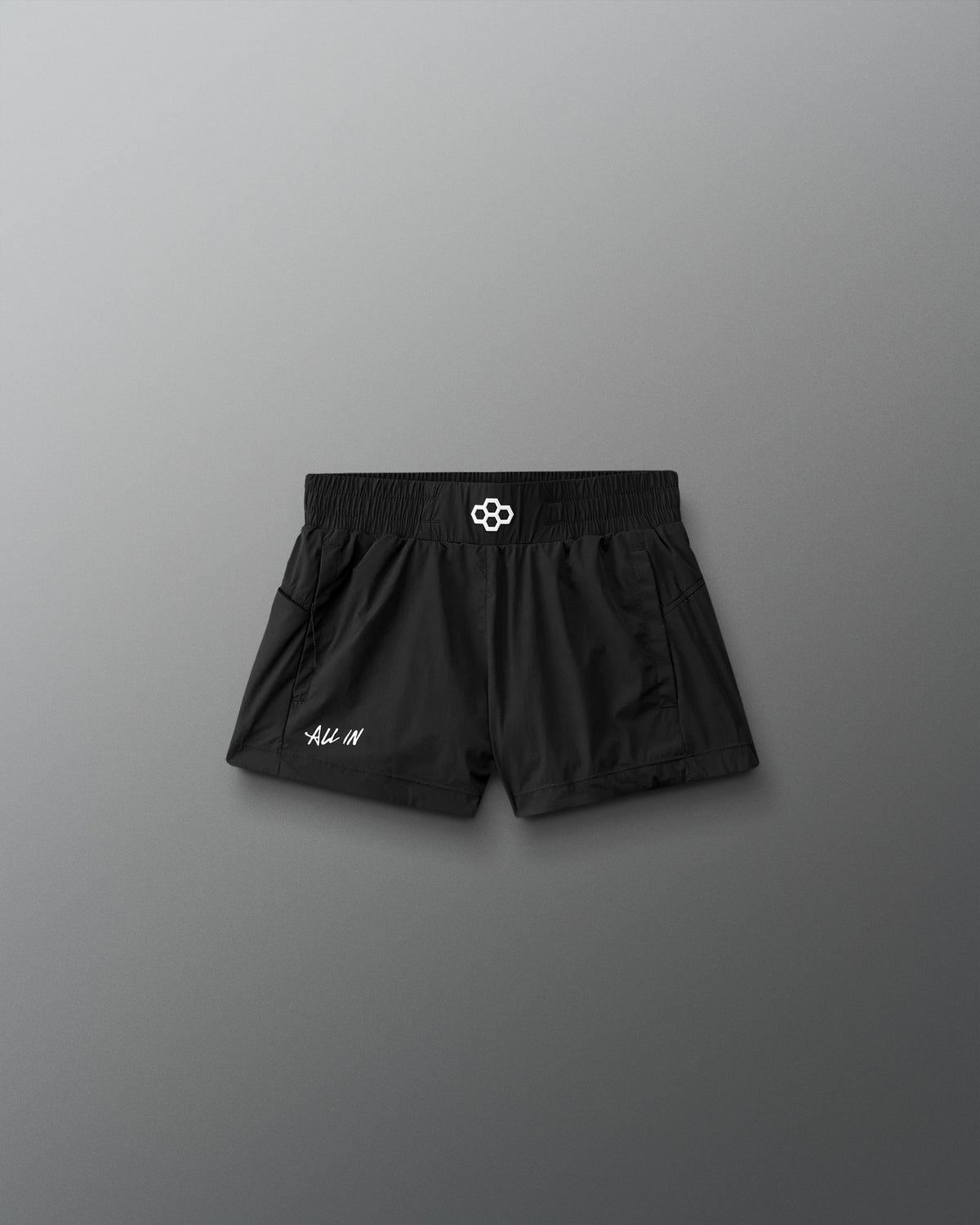 Black shorts with a brand logo on a gray background