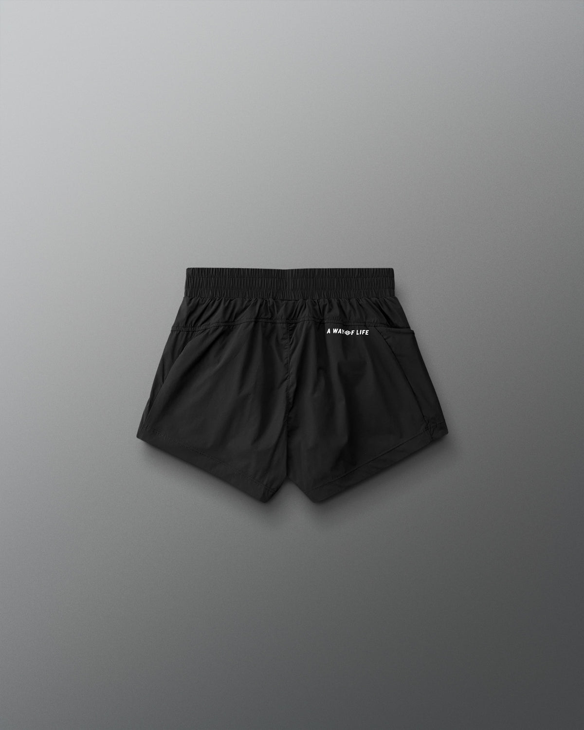 Black shorts with a brand logo on a gray background