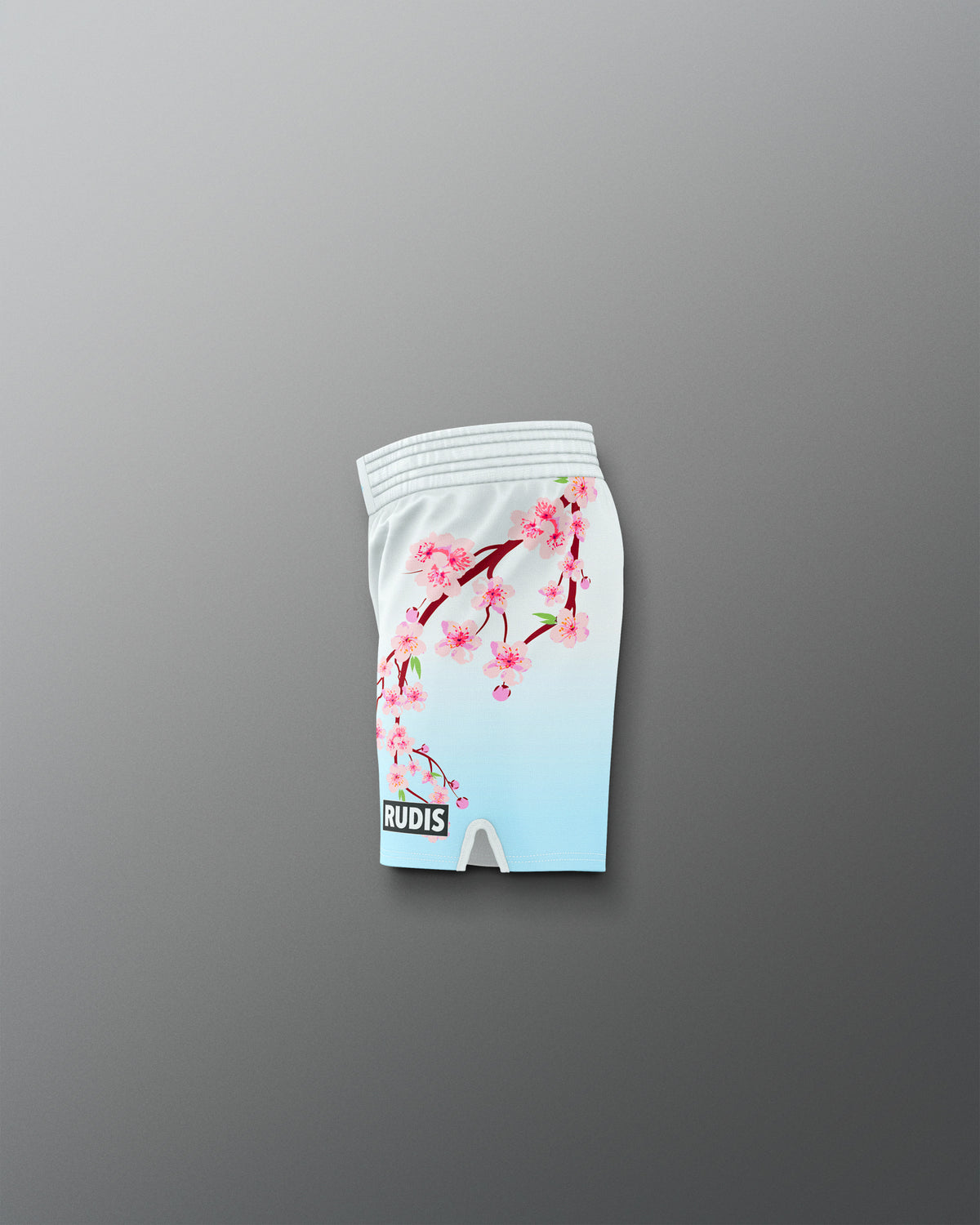 White shorts with cherry blossom design on a gray background