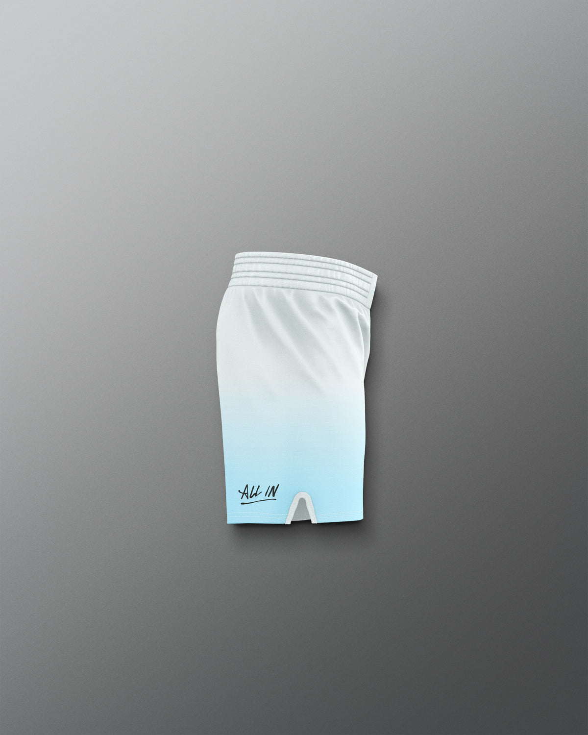 White athletic shorts with a logo on a gray background