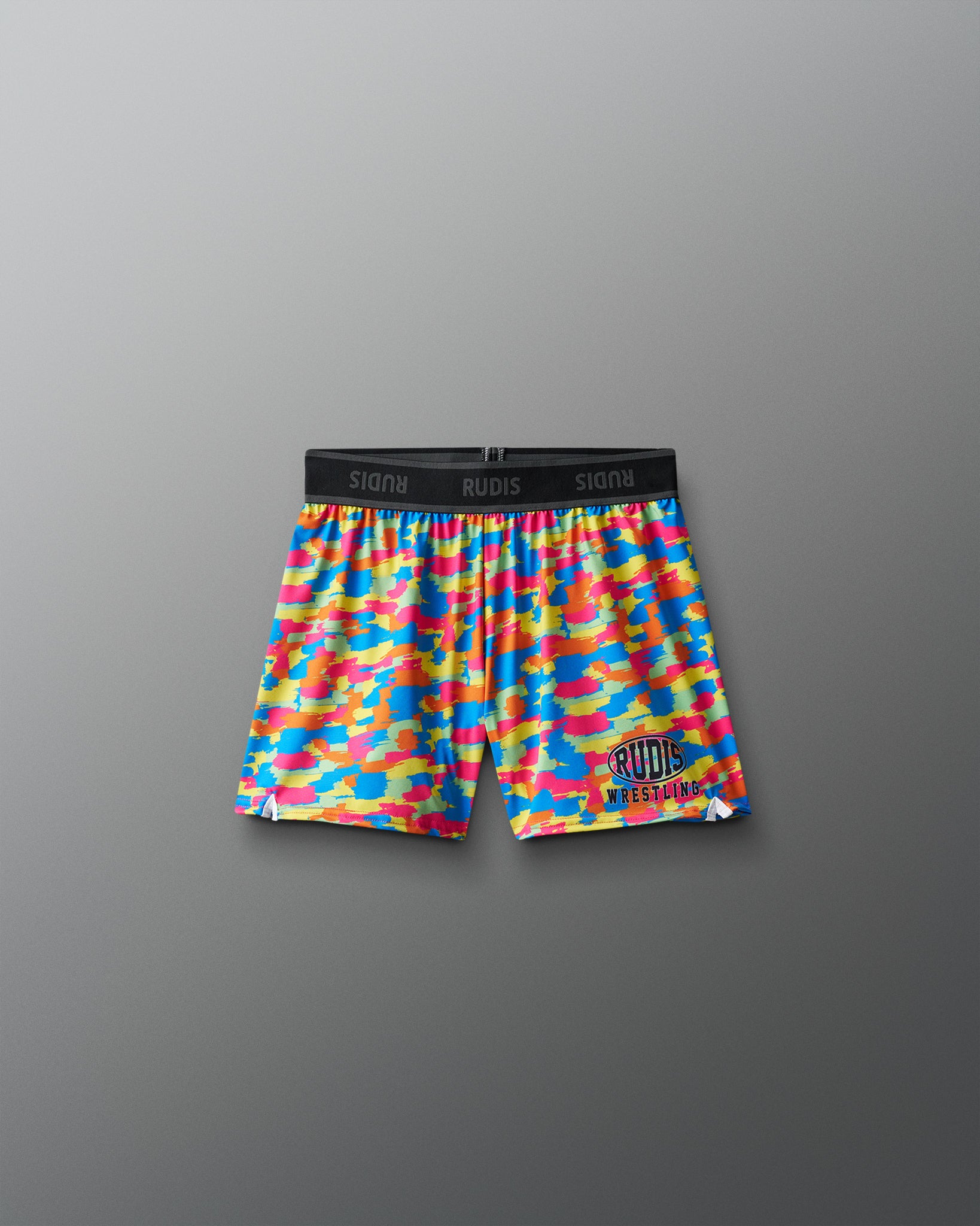 Colorful camouflage wrestling shorts with a brand logo on a gray background