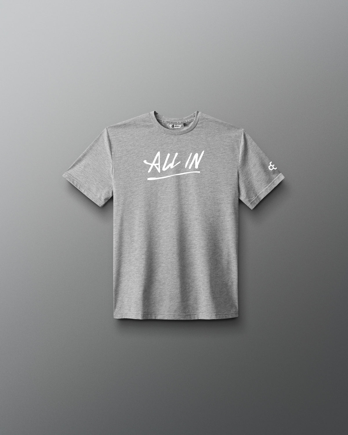 A heather gray short-sleeve t-shirt with 'ALL IN' printed in white script across the chest, displayed against a dark gray gradient background.