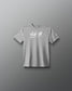 A heather gray short-sleeve t-shirt with 'ALL IN' printed in white script across the chest, displayed against a dark gray gradient background.