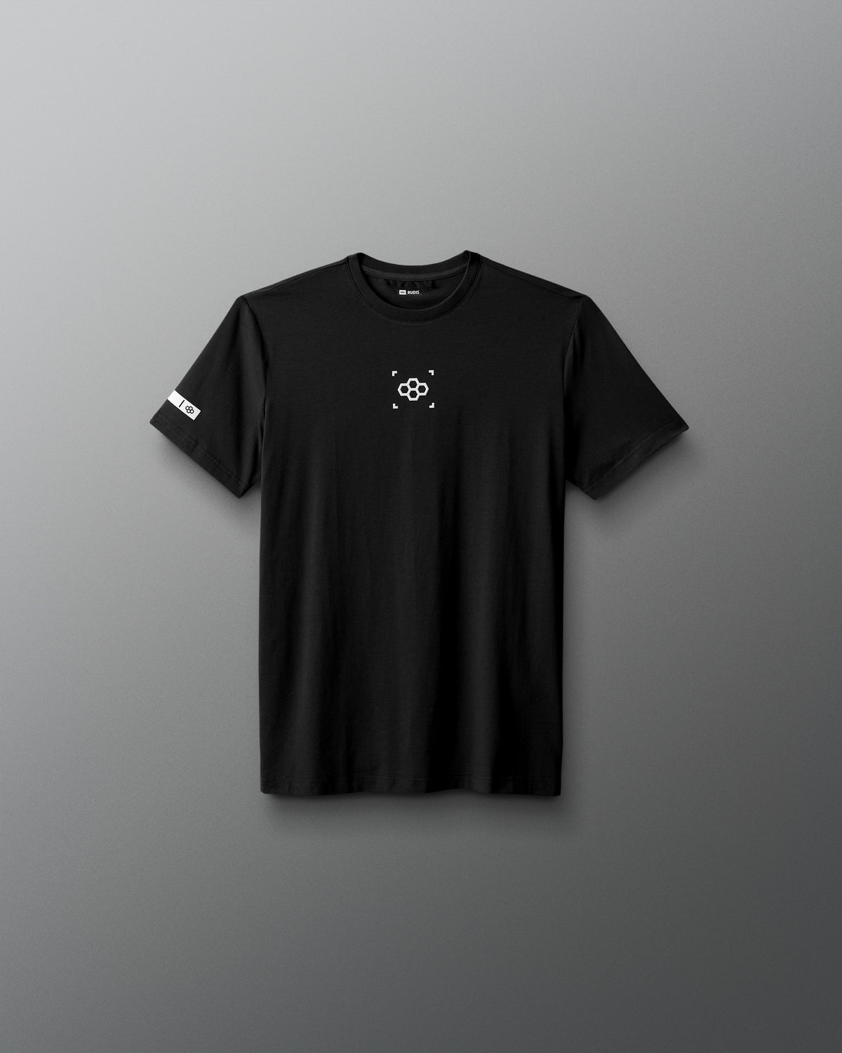 Black t-shirt with a small logo on a gray background