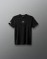 Black t-shirt with a small logo on a gray background
