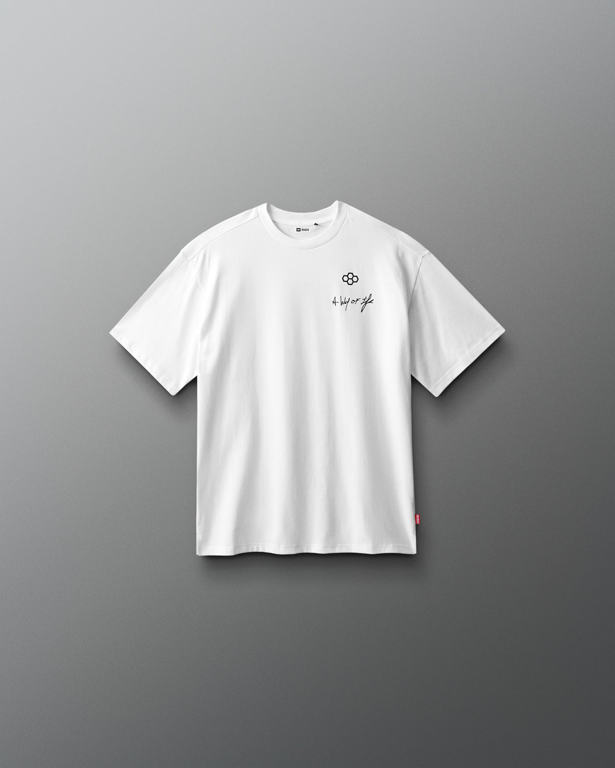 White t-shirt with a small logo on a gray background