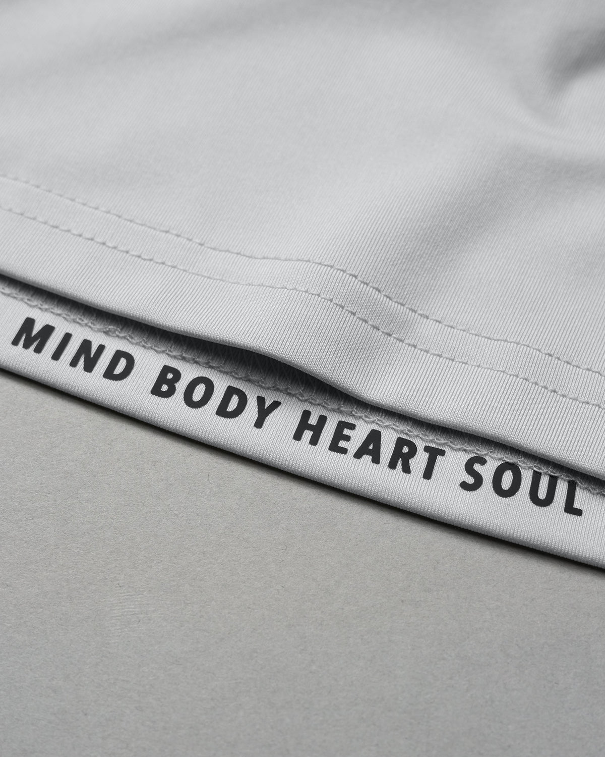 Gray shorts with 'Mind Body Heart Soul' text on waistband