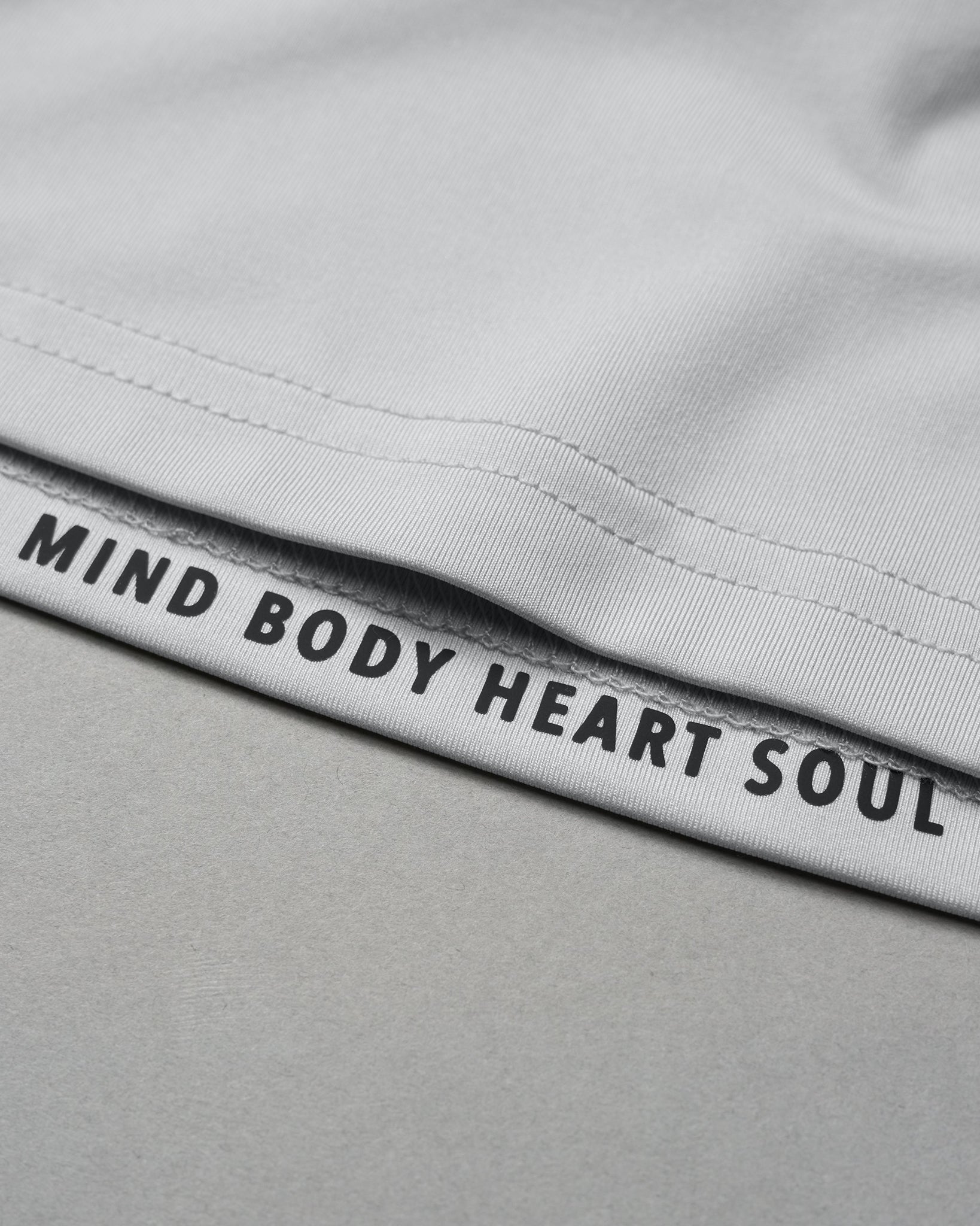Gray shorts with 'Mind Body Heart Soul' text on waistband