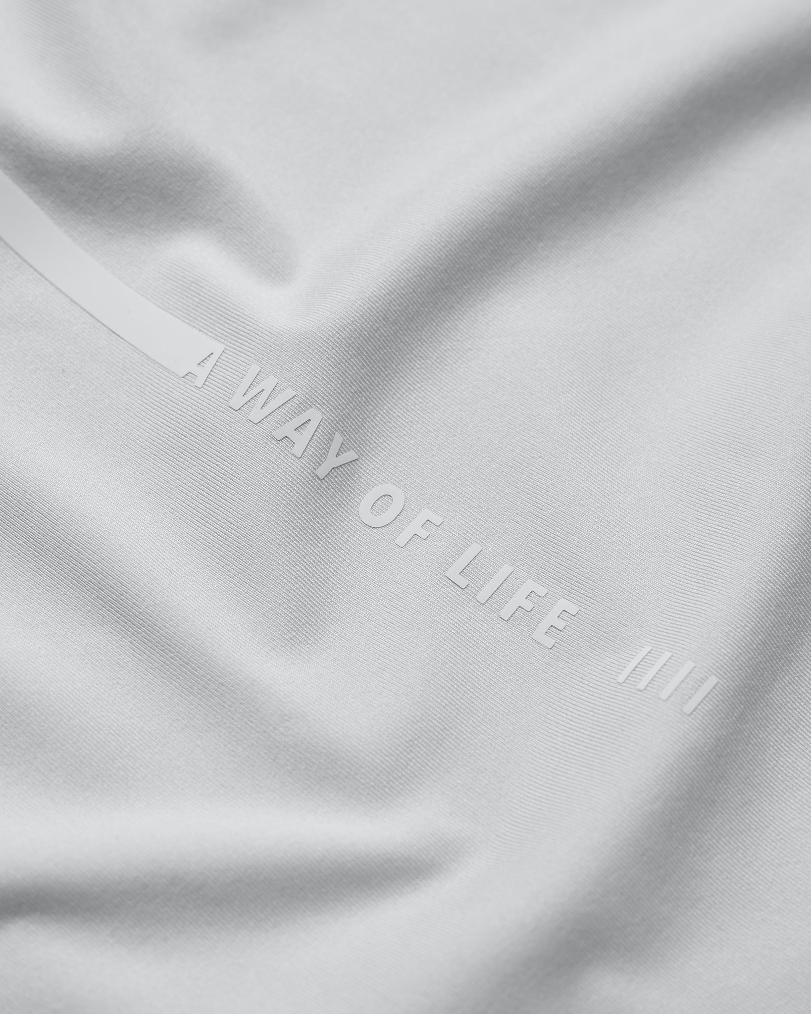 Gray fabric with 'A Way of Life' embroidery on a gray background