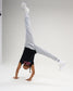 Youth athlete performs a handstand in the black RUDIS Girl Power Wrestling Youth Elite Super Soft T-Shirt with gray joggers and white shoes.