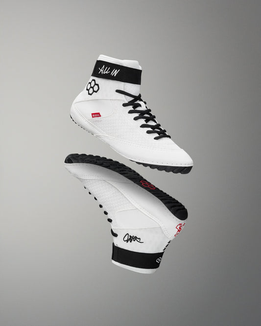 White wrestling shoes with black accents on a gray background
