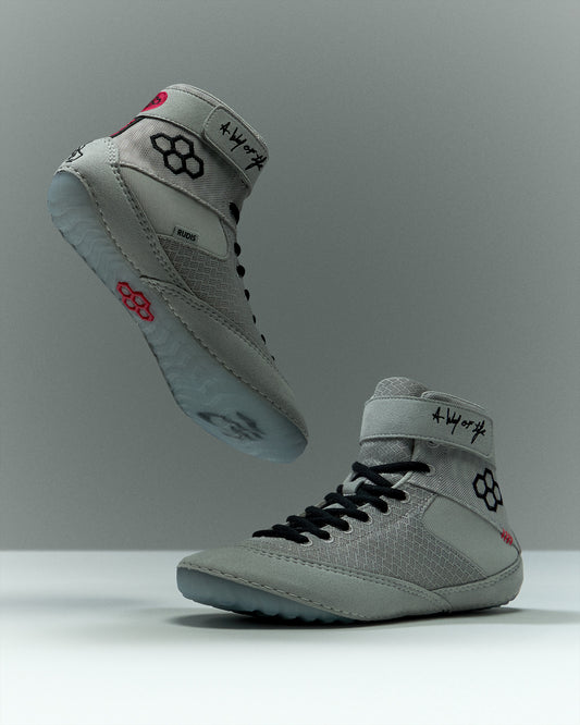 RUDIS Samurai Speed Youth Wrestling Shoes in Kokoro, featuring light gray mesh uppers, black laces, ankle straps, translucent blue outsoles, and red RUDIS accents.