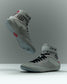 RUDIS Samurai Speed Youth Wrestling Shoes in Kokoro, featuring light gray mesh uppers, black laces, ankle straps, translucent blue outsoles, and red RUDIS accents.