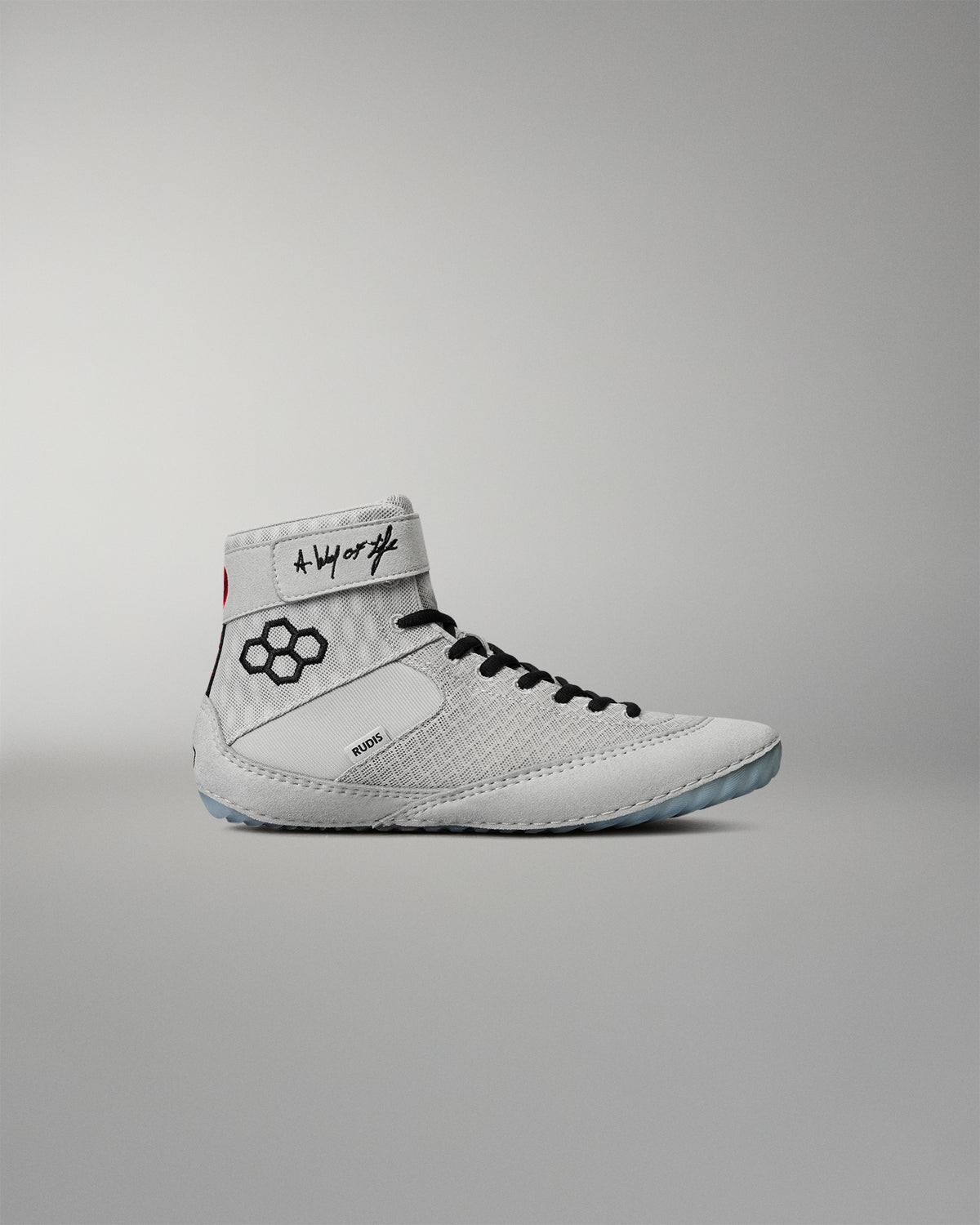 Lateral side view of the RUDIS Samurai Speed Youth Kokoro wrestling shoe, featuring a light gray mesh upper, black RUDIS emblem, ankle strap, and black laces.