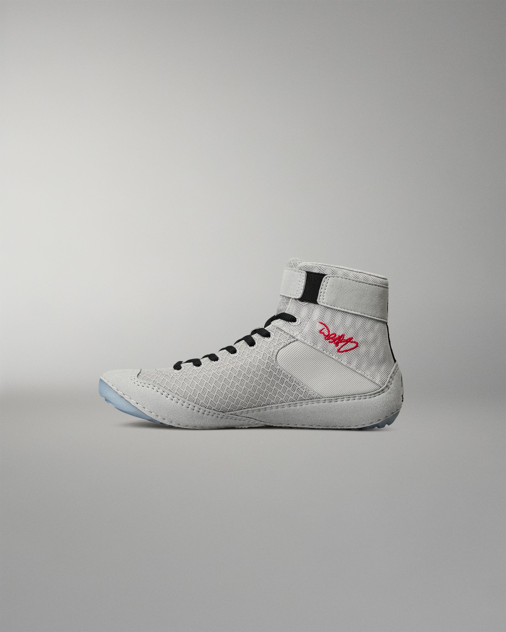 Medial side view of the RUDIS Samurai Speed Youth Kokoro wrestling shoe, showcasing textured gray mesh, black laces, red embroidered signature, and high-top ankle strap.
