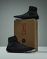 RUDIS Samurai Speed Youth Wrestling Shoes in Wabi-Sabi black displayed on and beside a RUDIS shoebox featuring red Japanese-inspired lettering and branding.
