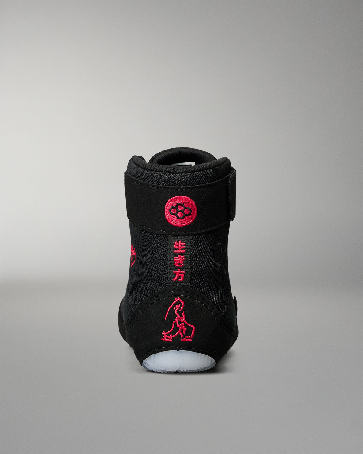 Rear view of the RUDIS Samurai Speed Youth Wabi-Sabi wrestling shoe, highlighting red embroidered Japanese characters, wrestling artwork, and RUDIS branding on the black heel.