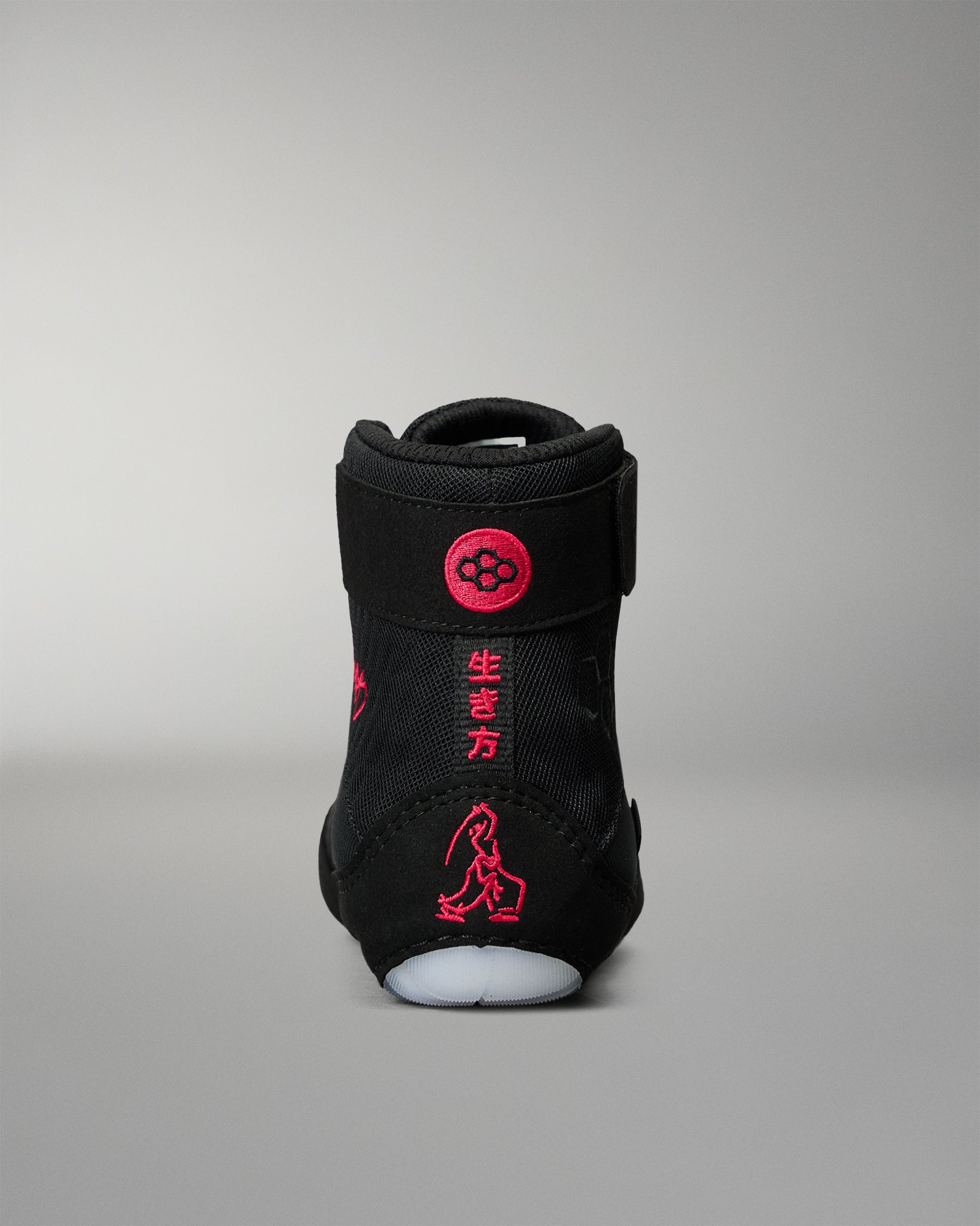 Rear view of the RUDIS Samurai Speed Youth Wabi-Sabi wrestling shoe, highlighting red embroidered Japanese characters, wrestling artwork, and RUDIS branding on the black heel.