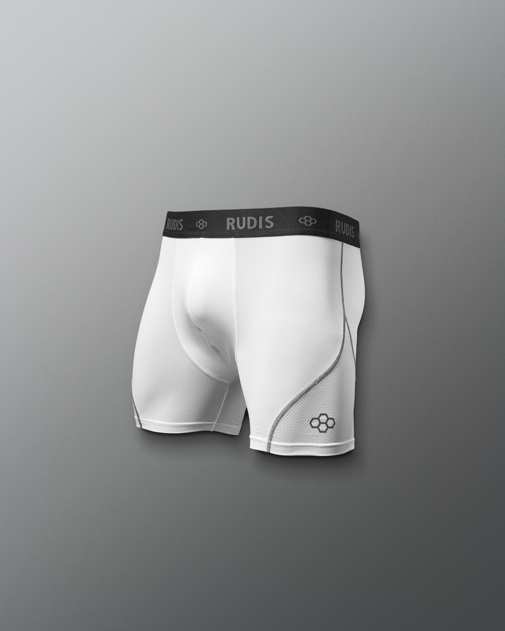 White athletic boxers with black waistband featuring 'RUDIS' brand on a gray background
