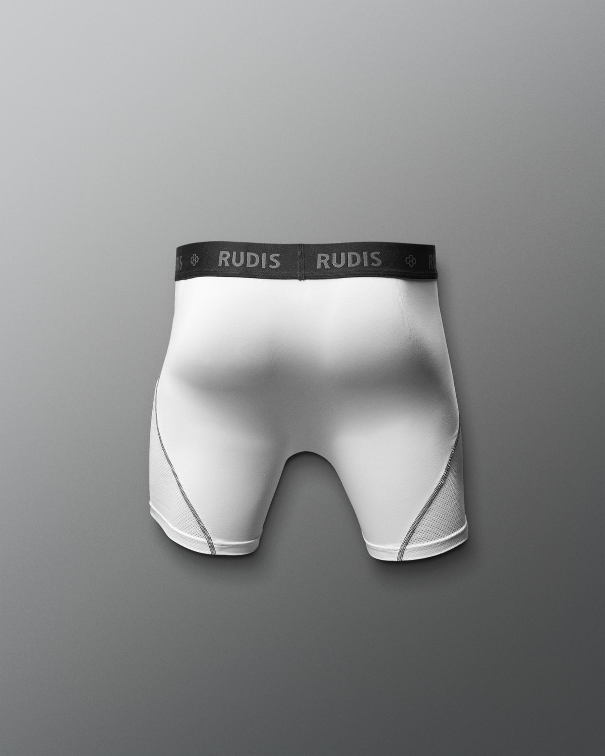 White boxer briefs with black waistband featuring 'RUDIS' brand on a gray background