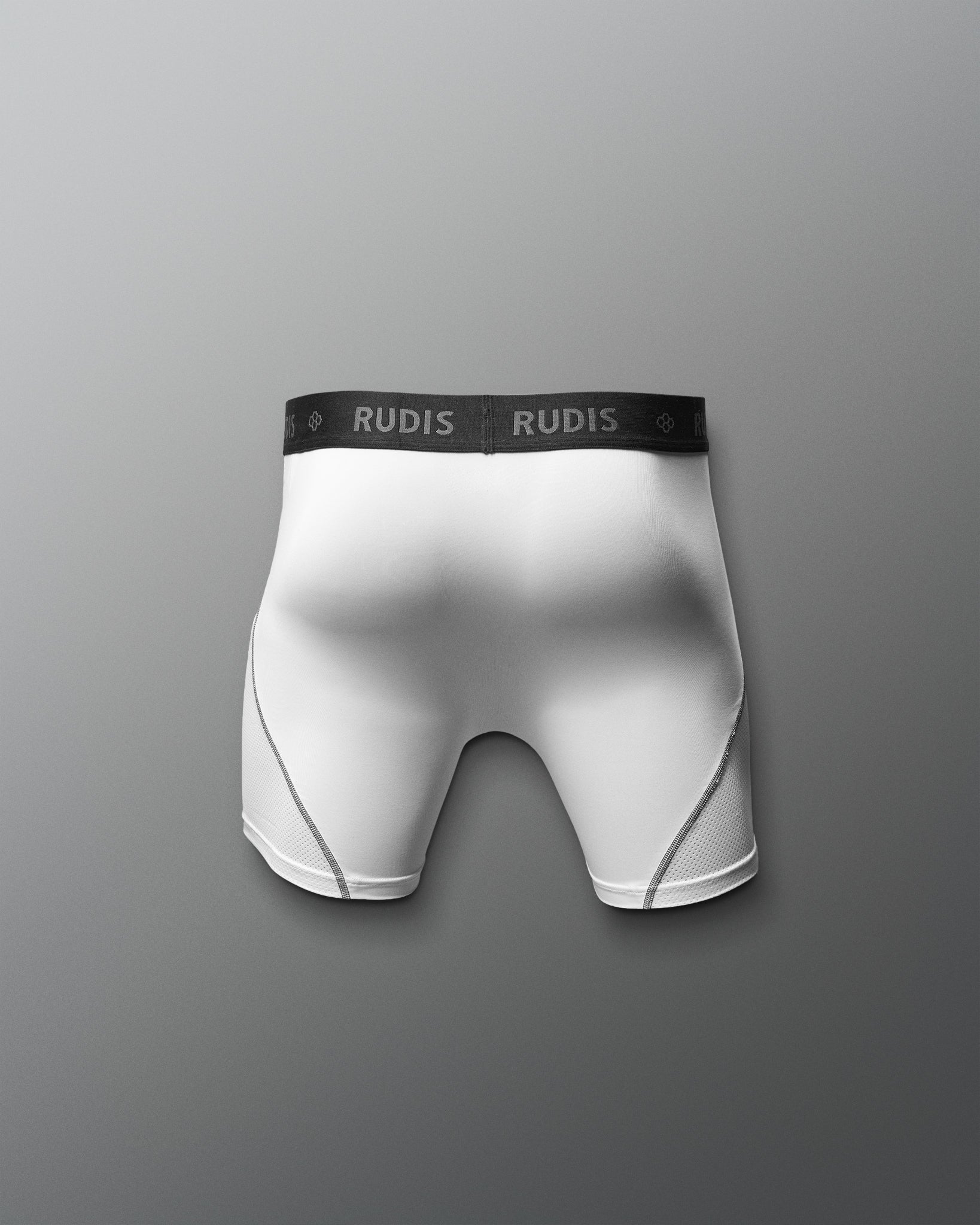 White boxer briefs with black waistband featuring 'RUDIS' brand on a gray background