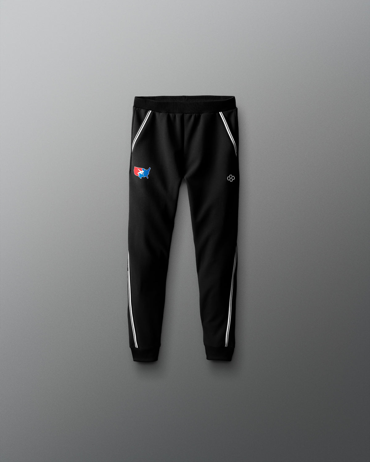 Black jogger pants with logos on a gradient red to blue background