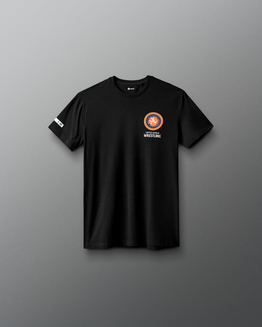 Black t-shirt with a logo on the chest against a gray background