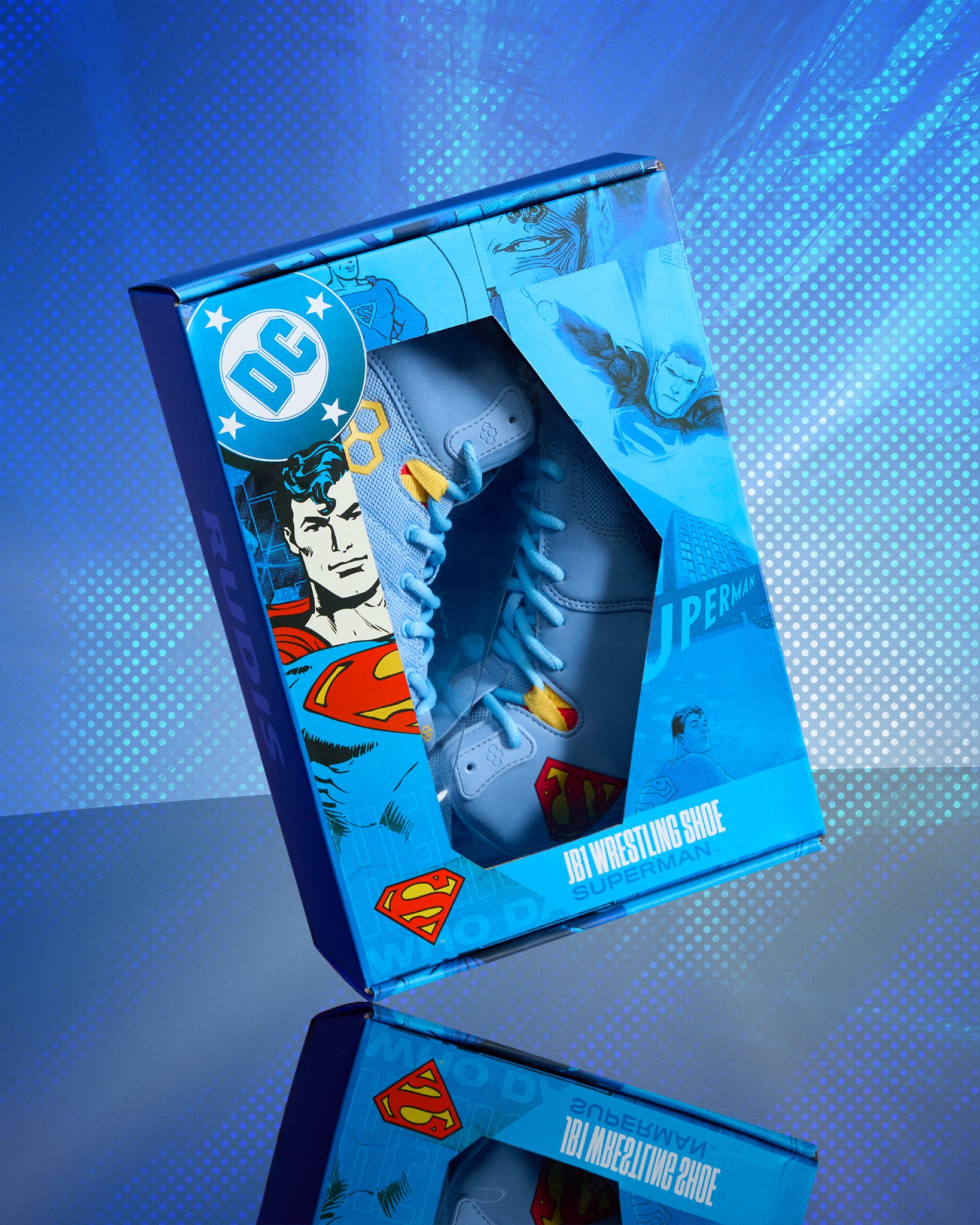 RUDIS JB1 Superman wrestling shoes displayed in DC Superman collector packaging with comic artwork.