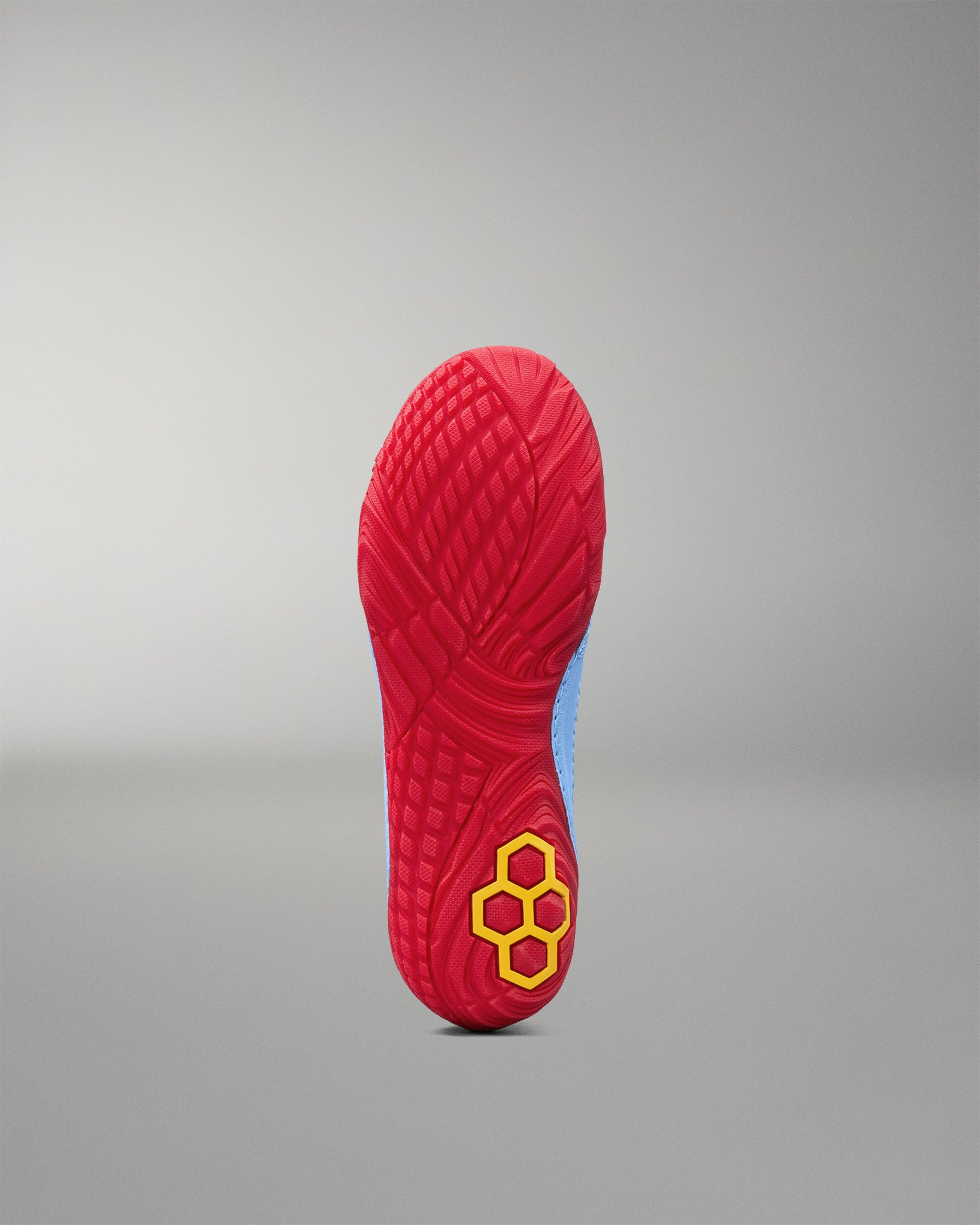 Bottom view of RUDIS JB1 Superman wrestling shoe showing the textured red outsole and yellow RUDIS logo.