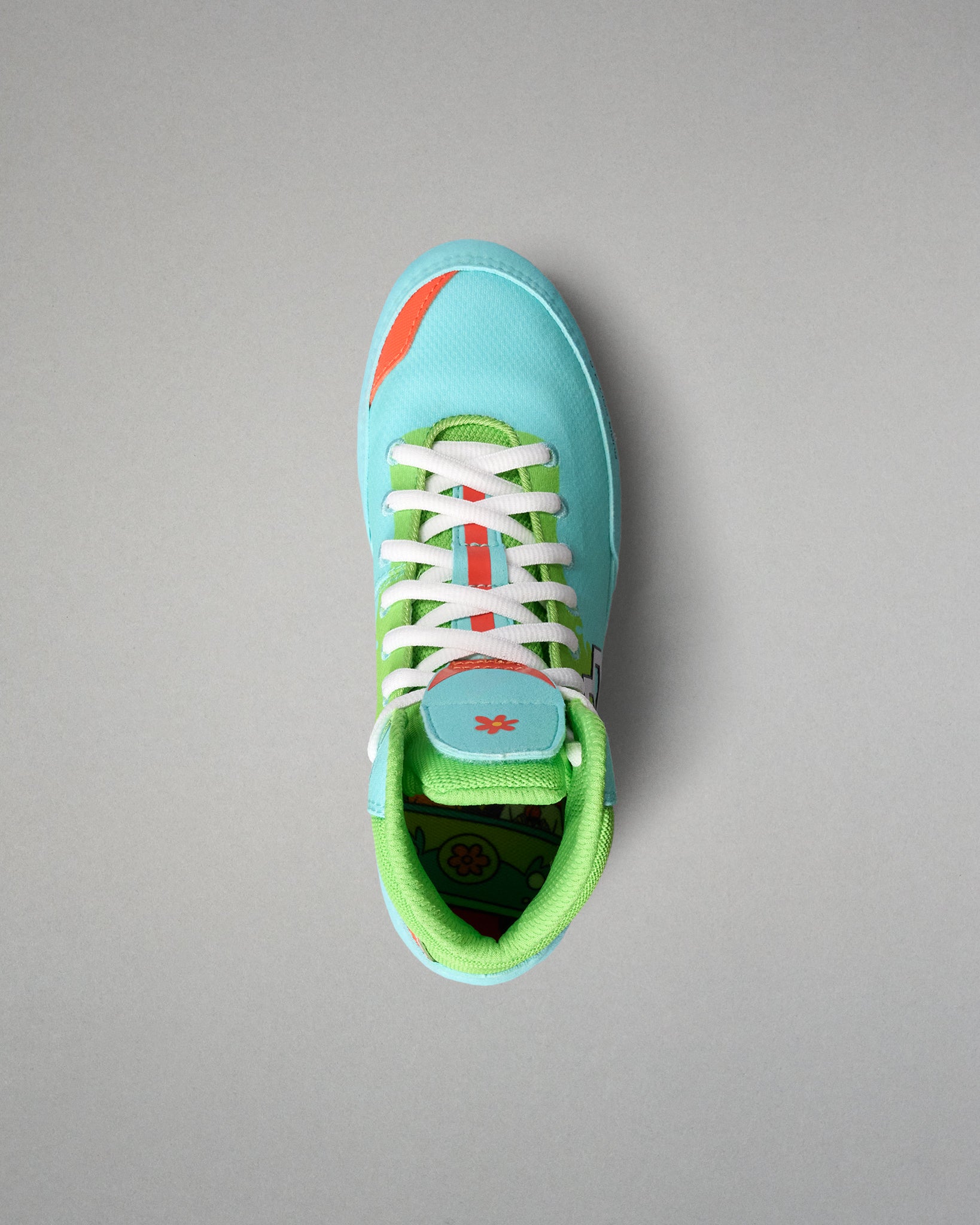 Top view of the RUDIS Scooby-Doo Colt 4.0 youth wrestling shoe showing white laces, turquoise toe box, green padded collar, and Mystery Machine-themed insole artwork.