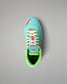 Top view of the RUDIS Scooby-Doo Colt 4.0 youth wrestling shoe showing white laces, turquoise toe box, green padded collar, and Mystery Machine-themed insole artwork.