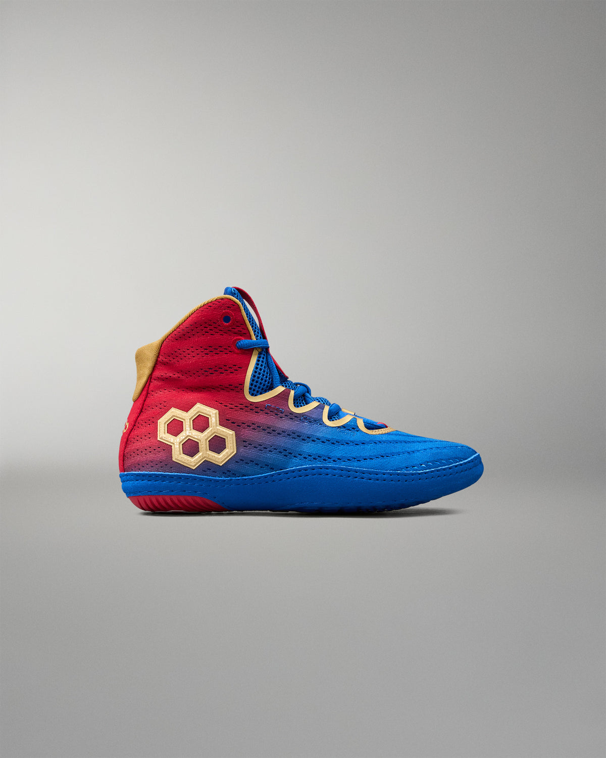 Outer side view of RUDIS Wonder Woman Hildebrandt 2.0 girls' wrestling shoe with a red-to-blue gradient upper, gold RUDIS logo, blue laces and gold trim.