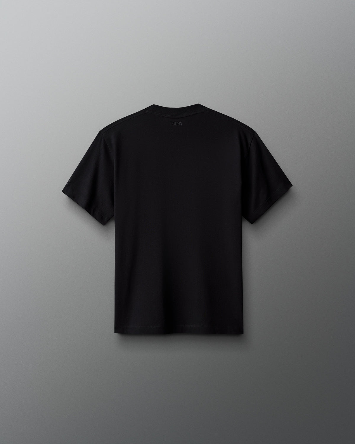 Back view of the RUDIS Scooby-Doo Youth Relaxed Cotton T-Shirt in black, featuring a solid black design, short sleeves, crew neckline, and subtle RUDIS branding below the back collar.